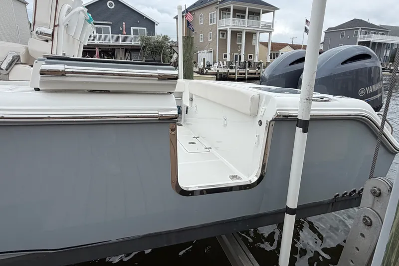 Slide: The Image of 2019 Sea Hunt Gamefish 25 boat with Yamaha engines docked near waterfront homes. - 8