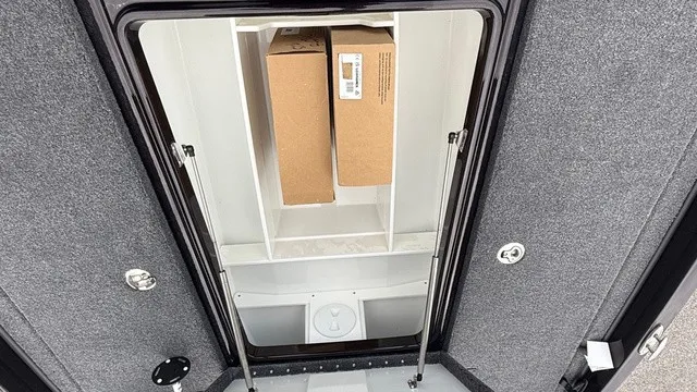Slide: The Image of A storage compartment in a boat's floor with two boxes inside. - 18