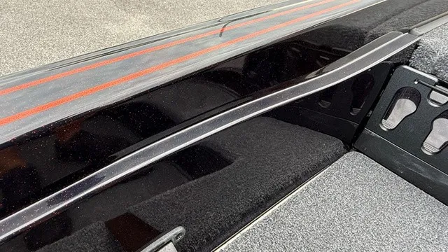 Slide: The Image of Close-up of a Phoenix 721 ZXL boat deck with black and red design. - 20