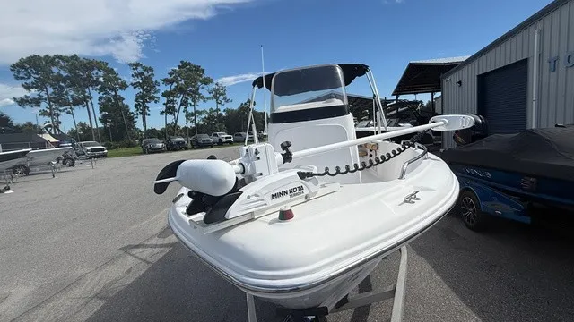 Slide: The Image of A white 2007 Pro-Line sport boat on a trailer, featuring a Minn Kota motor. - 7