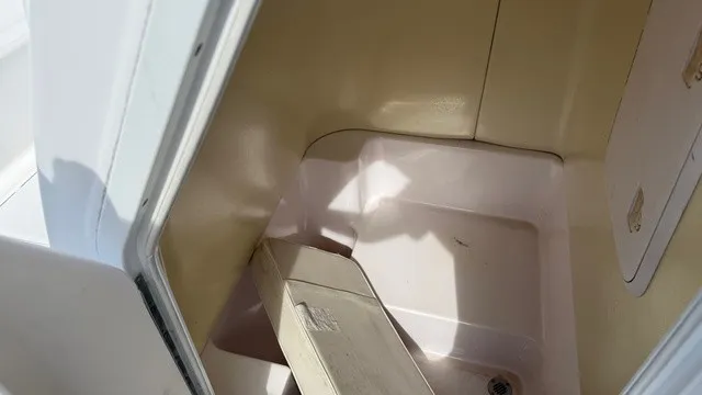 Slide: The Image of Interior view of a boat cabin area with beige flooring and white walls. - 20