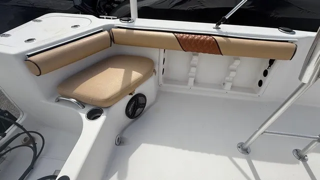 Slide: The Image of The image shows the seating area of a 2007 Pro-Line SPORT SERIES 20 boat with beige cushions. - 15