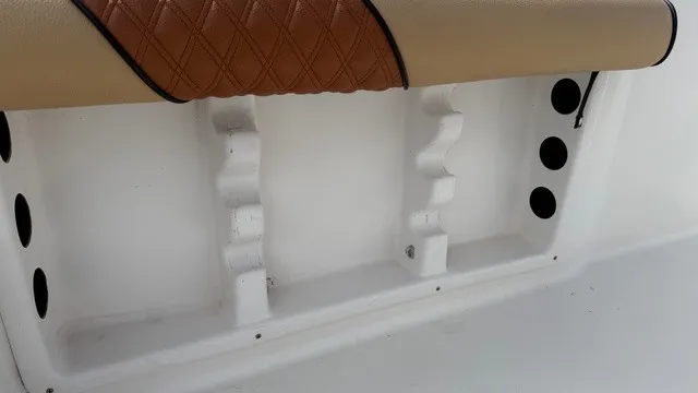 Slide: The Image of Close-up of a boat interior with padded seating and rod holders. - 18
