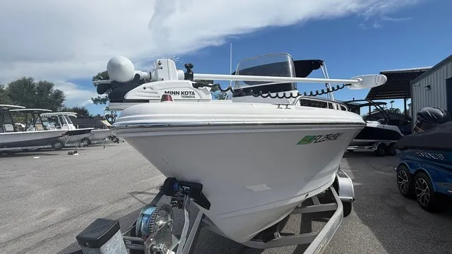 Slide: The Image of A white 2007 Pro-Line sport boat on a trailer in a marina area. - 8