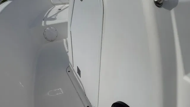 Slide: The Image of Close-up of a white boat deck with a door and round openings. - 19
