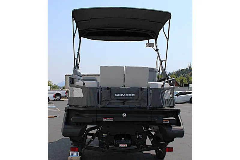 Slide: The Image of 2023 Sea-Doo Switch Sport Compact pontoon boat, rear view in parking lot. - 7