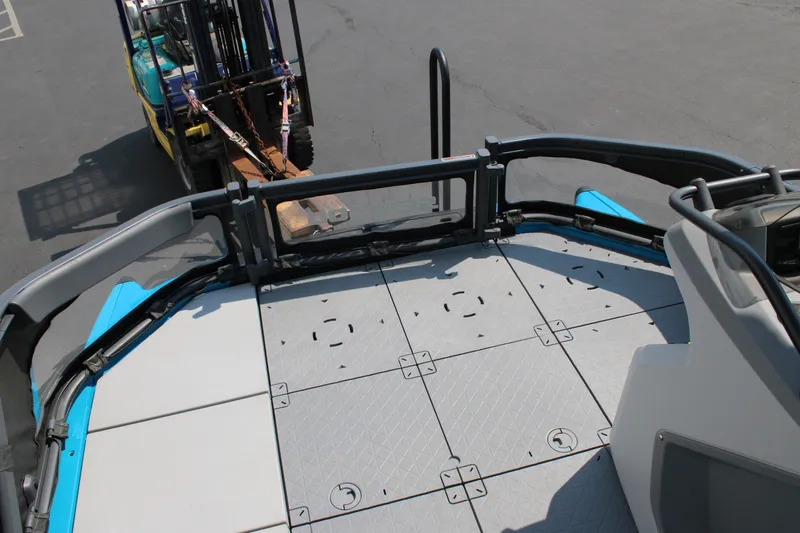 Slide: The Image of 2023 Sea-Doo Switch Sport Compact deck view with forklift in background. - 25