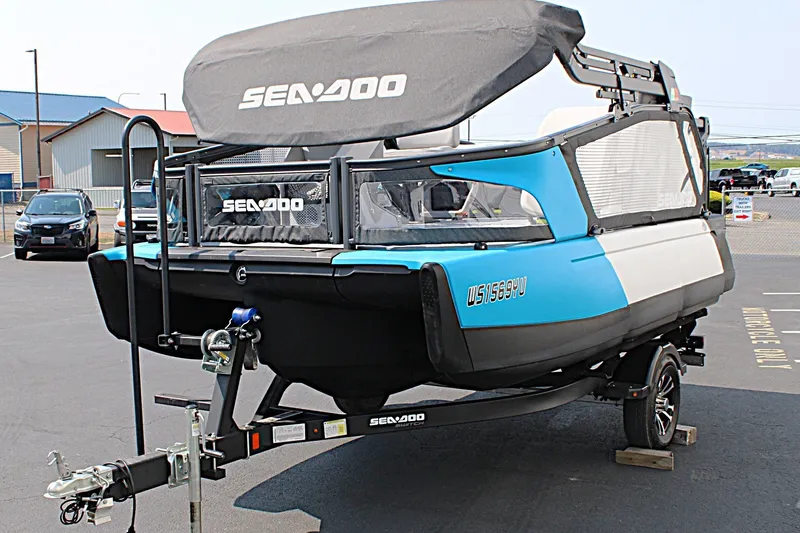 Slide: The Image of 2023 Sea-Doo Switch Sport Compact on trailer, blue and black design, parked outdoors. - 18