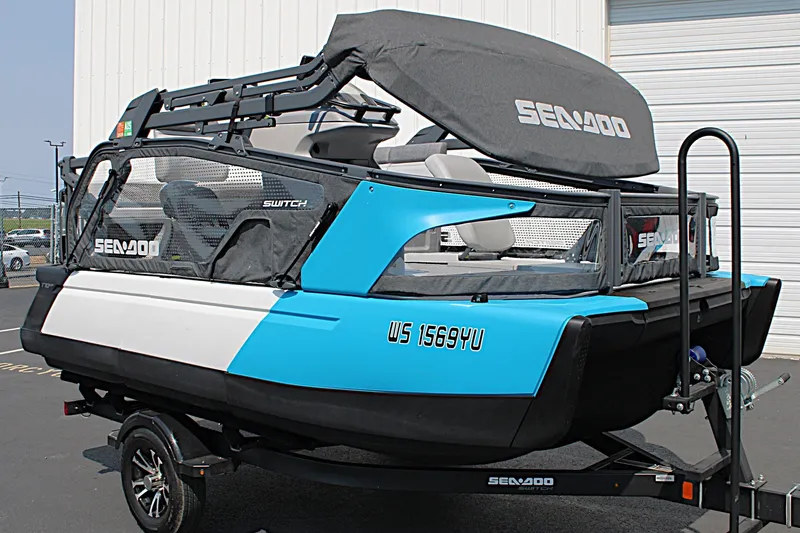 Slide: The Image of 2023 Sea-Doo Switch Sport Compact on trailer, featuring blue and white design. - 13