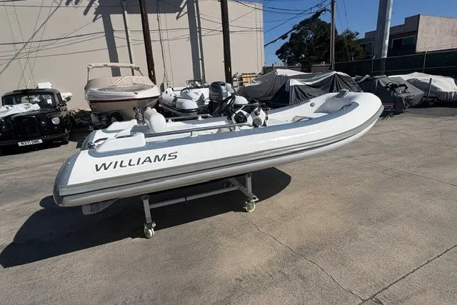 Slide: The Image of 2018 Williams Jet Tenders Sportjet 395 on display outdoors, surrounded by other boats. - 3
