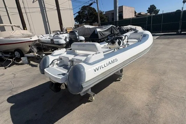Slide: The Image of 2018 Williams Jet Tenders Sportjet 395 boat on display outdoors. - 5