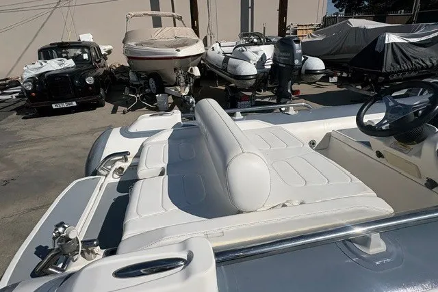 Slide: The Image of 2018 Williams Jet Tenders Sportjet 395 with white seating, parked among other boats. - 9