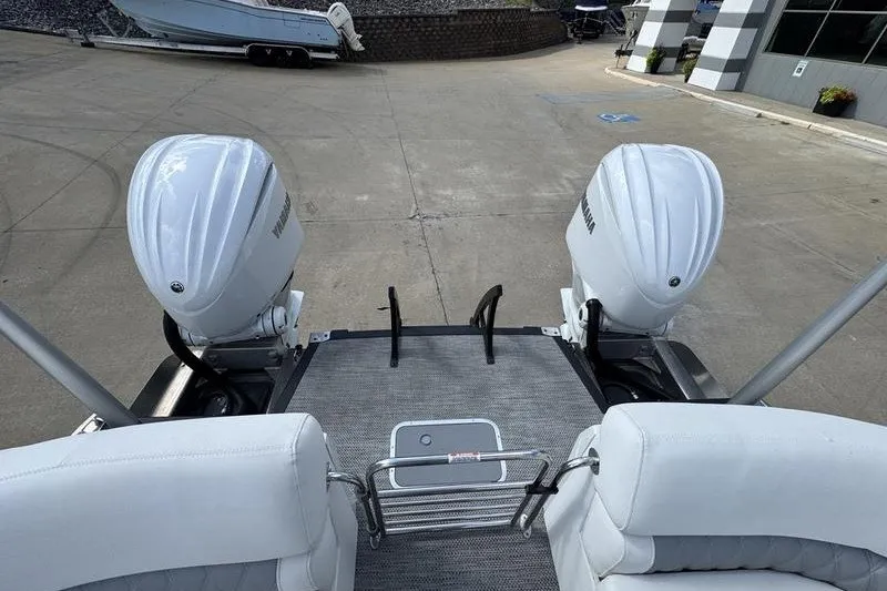 Slide: The Image of 2024 Bennington 30 QXFBAX2 boat with twin Yamaha outboard engines, docked on concrete. - 5