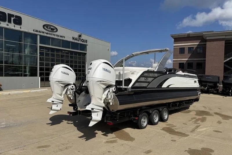 Slide: The Image of 2024 Bennington 30 QXFBAX2 boat with dual Yamaha engines on a trailer. - 2