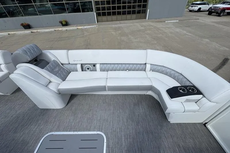 Slide: The Image of Luxurious seating on 2024 Bennington 30 QXFBAX2 pontoon boat, featuring plush upholstery and cup holders. - 11