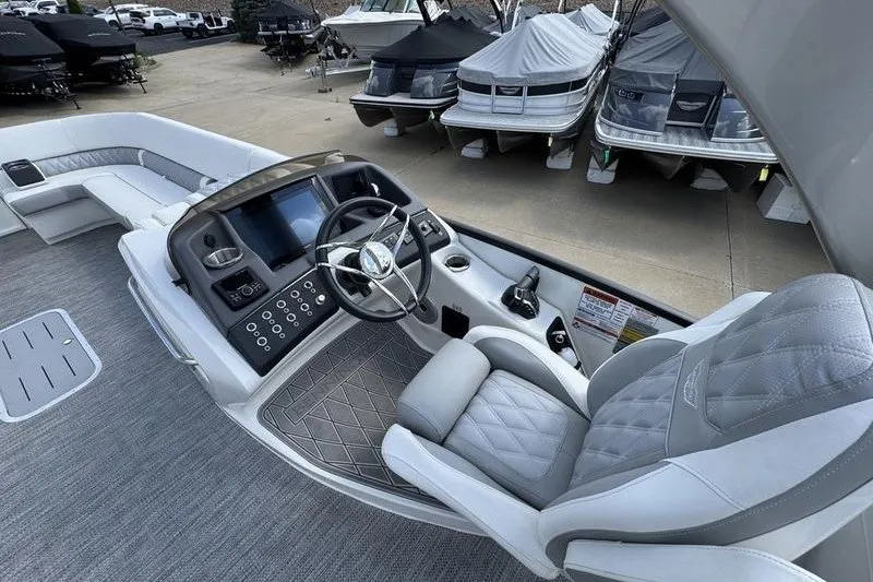 Slide: The Image of 2024 Bennington 30 QXFBAX2 boat interior with luxurious seating and modern dashboard. - 10