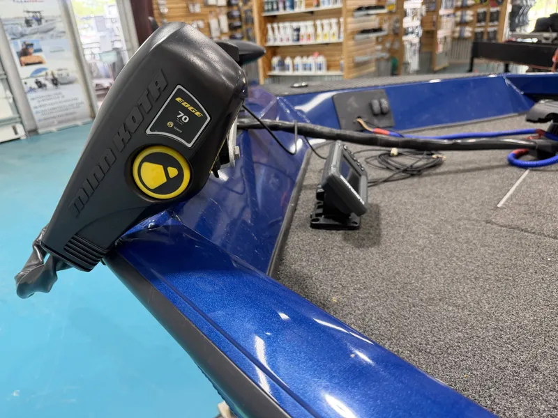 Slide: The Image of Close-up of a blue boat with Minn Kota motor and electronics on the deck. - 17