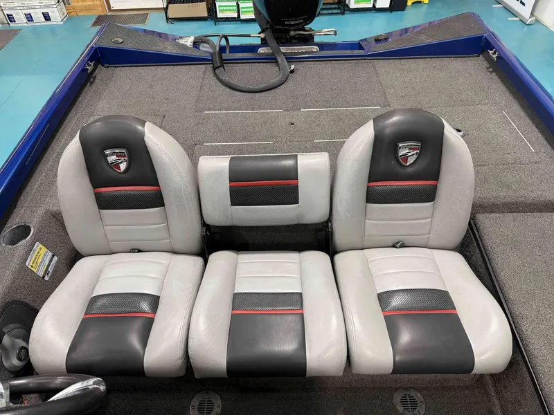 Slide: The Image of The image shows the seats of a 2017 Triton 18CTX boat with gray and black upholstery. - 18