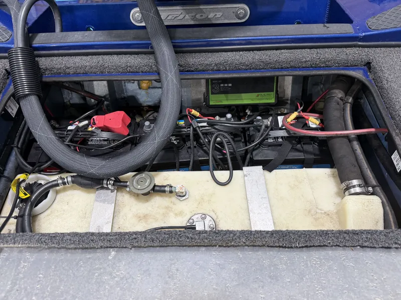 Slide: The Image of An open compartment in the boat reveals batteries, wiring, and a fuel tank. - 19