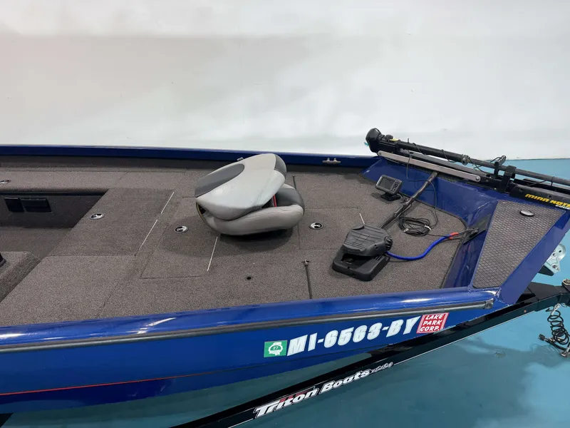 Slide: The Image of A blue 2017 Triton 18CTX with a gray seat and controls on the deck. - 23