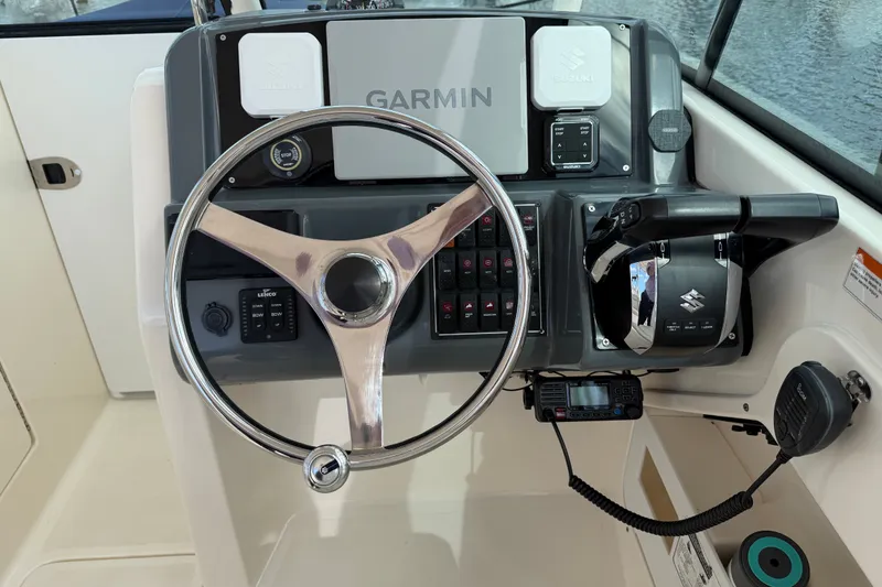Slide: The Image of Steering console of a 2013 Pursuit DC 265 Dual Console boat with Garmin navigation. - 8