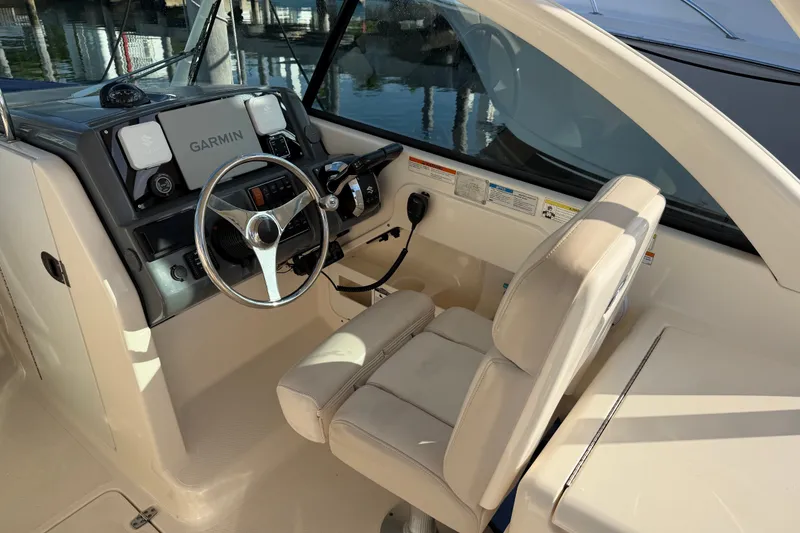Slide: The Image of 2013 Pursuit DC 265 Dual Console boat cockpit with Garmin navigation system. - 7