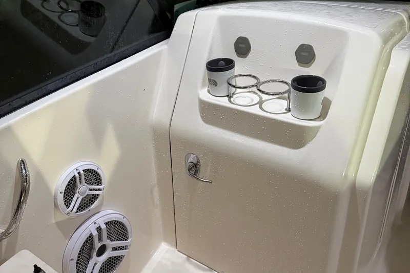 Slide: The Image of Interior of 2013 Pursuit DC 265 Dual Console with cup holders and speakers. - 16