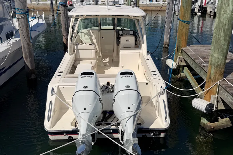Slide: The Image of 2013 Pursuit DC 265 Dual Console boat docked with twin 200 horsepower engines. - 3