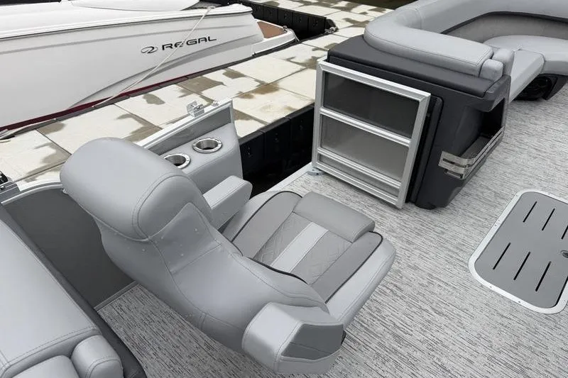 Slide: The Image of 2025 Bennington 24 MFB pontoon boat interior with gray seating and storage compartments. - 11