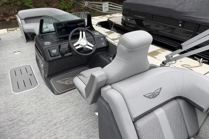 Slide: The Image of 2025 Bennington 24 MFB boat interior with modern steering console and luxurious seating. - 10