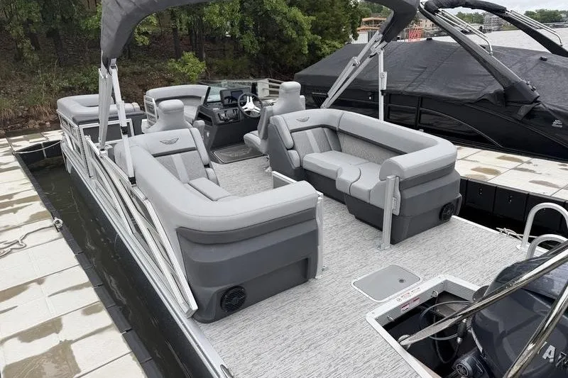 Slide: The Image of 2025 Bennington 24 MFB pontoon boat with spacious seating and modern design at dock. - 6