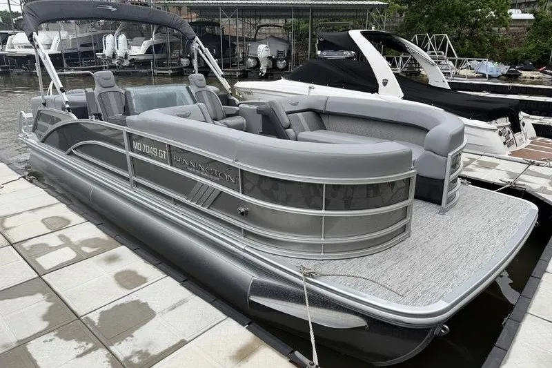 Slide: The Image of 2025 Bennington 24 MFB pontoon boat docked at a marina. - 3