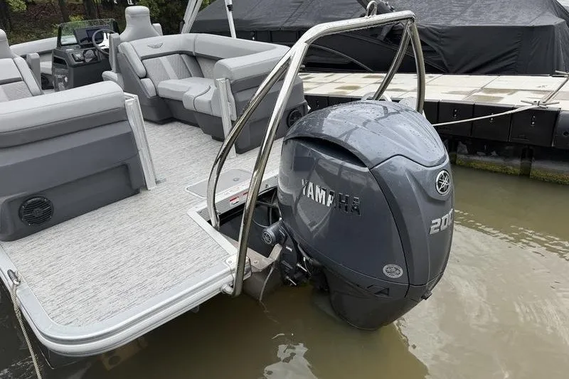 Slide: The Image of 2025 Bennington 24 MFB pontoon boat with Yamaha 200 outboard motor, docked on water. - 5