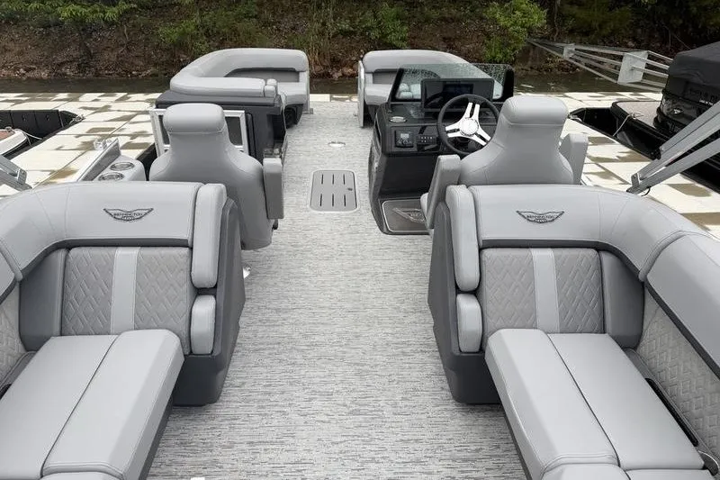 Slide: The Image of 2025 Bennington 24 MFB pontoon boat interior with luxurious gray seating and modern helm. - 9