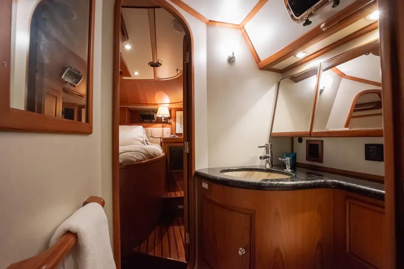 Slide: The Image of Luxurious interior of 2011 Hylas 56 yacht, featuring a cozy cabin and elegant bathroom. - 28