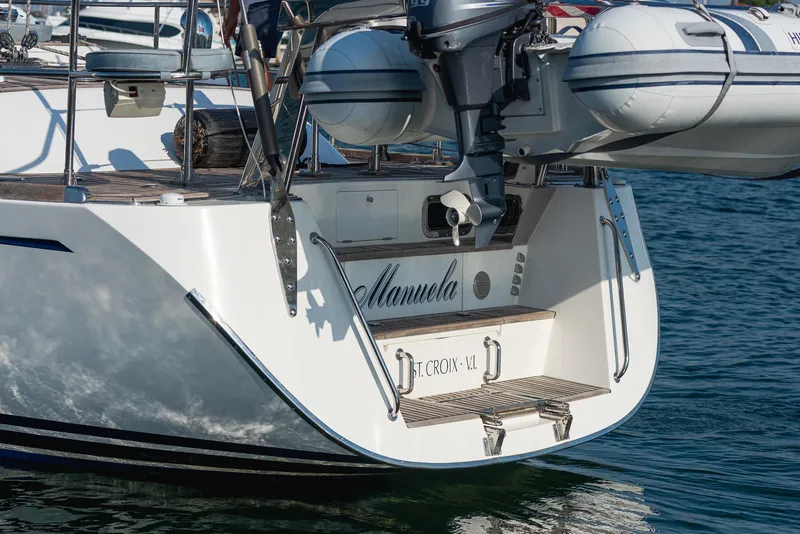Slide: The Image of Hylas 56 yacht, 2011 model, with dinghy attached, docked in calm waters. - 4