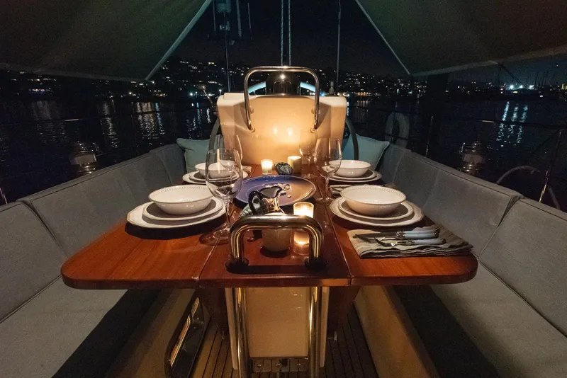 Slide: The Image of Luxurious dining setup on a 2011 Hylas 56 yacht at night. - 33