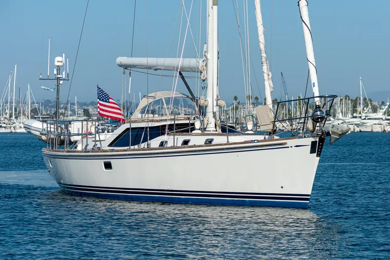 Slide: The Image of Sailing yacht Hylas 56, 2011 model, cruising in a marina with an American flag. - 6
