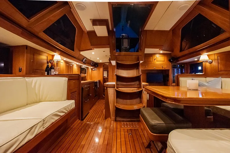 Slide: The Image of Luxurious interior of a 2011 Hylas 56 yacht with wooden finishes and cozy seating. - 23