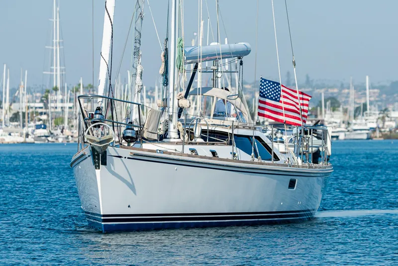 Slide: The Image of Sailing yacht Hylas 56, 2011 model, with American flag in marina. - 1