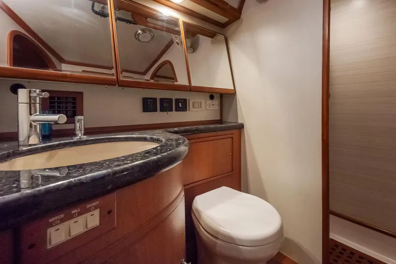 Slide: The Image of Luxurious bathroom in a 2011 Hylas 56 yacht with modern fixtures and wood accents. - 29