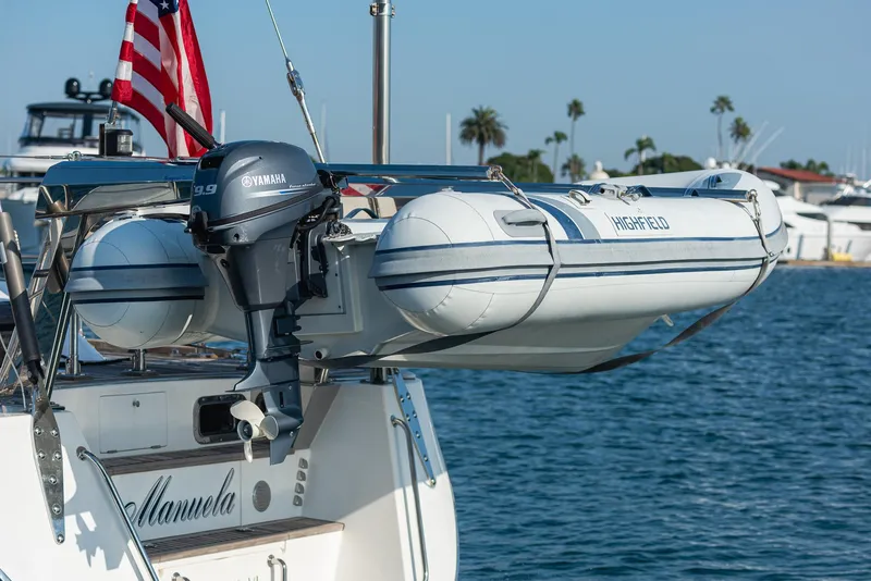 Slide: The Image of Hylas 56 yacht with dinghy and Yamaha motor, docked in a marina, 2011 model. - 16
