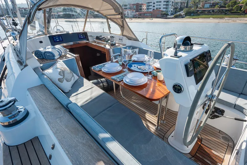 Slide: The Image of Luxurious 2011 Hylas 56 yacht interior with elegant dining setup and modern navigation equipment. - 8