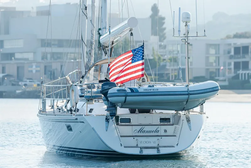 Slide: The Image of Sailing yacht Hylas 56 (2011) with American flag and dinghy, docked in a marina. - 3