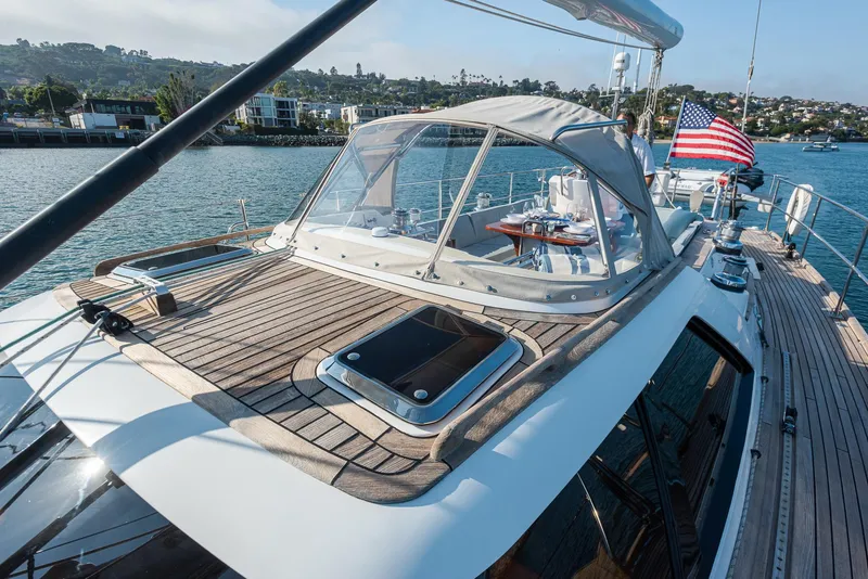 Slide: The Image of Sailing yacht Hylas 56, 2011 model, with American flag, docked in scenic marina. - 11