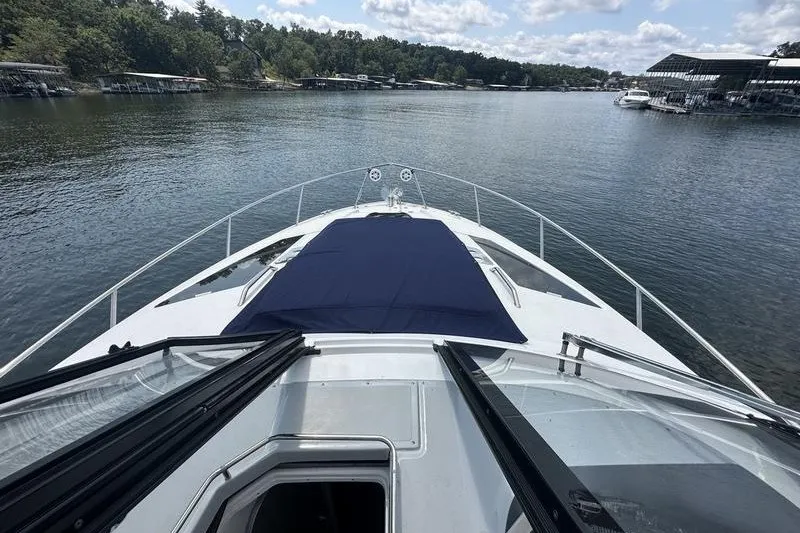 Slide: The Image of 2019 Regal 35 Sport Coupe yacht cruising on a serene lake. - 8