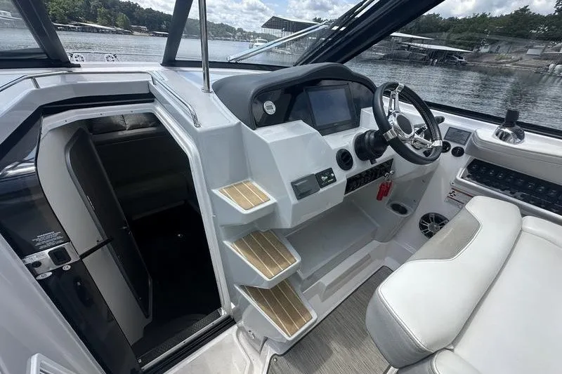 Slide: The Image of 2019 Regal 35 Sport Coupe cockpit with modern controls and waterfront view. - 7