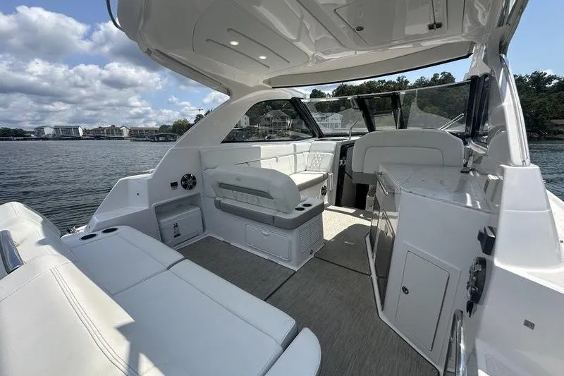 Slide: The Image of 2019 Regal 35 Sport Coupe interior with white seating, open water view, and modern design. - 16