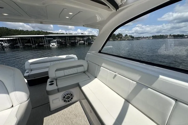 Slide: The Image of Interior of 2019 Regal 35 Sport Coupe yacht with white seating and lake view. - 13