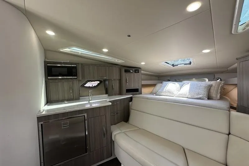 Slide: The Image of Interior of 2019 Regal 35 Sport Coupe with modern kitchen and cozy seating area. - 11